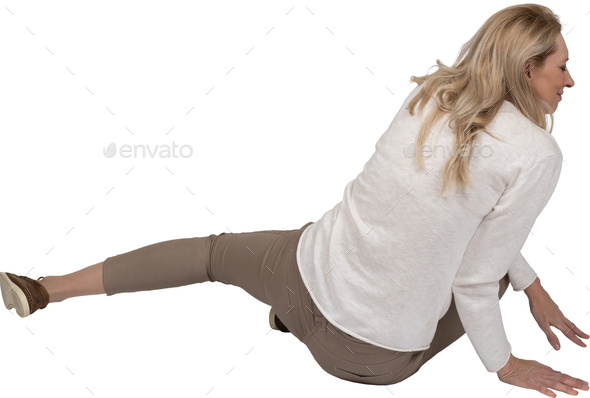 a woman is sitting on the floor with her leg up in the air