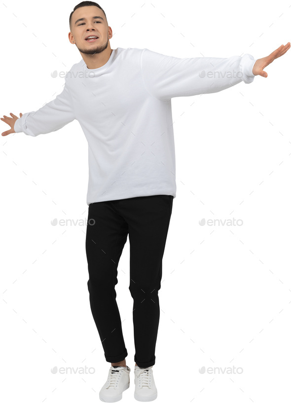 a man in a white sweatshirt and black pants with his arms outstretched