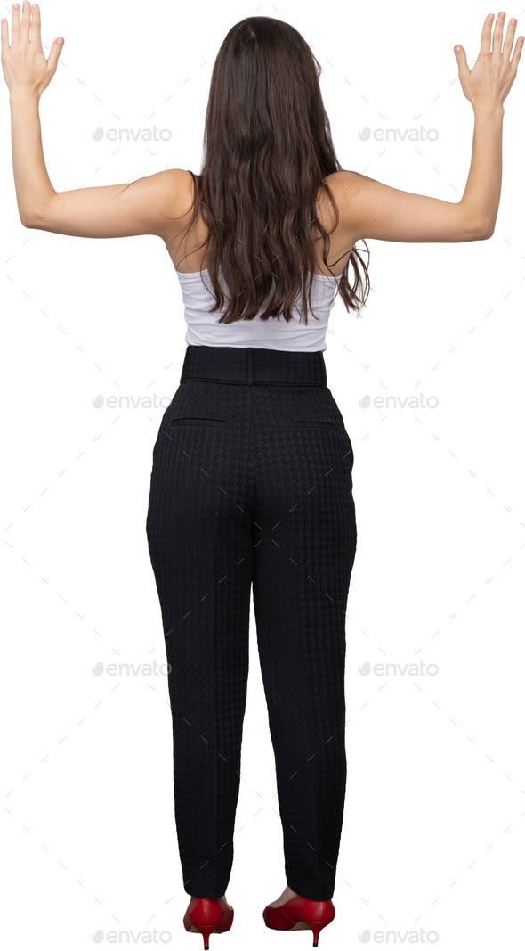 A woman standing behind a wall with her arms stretched out photo