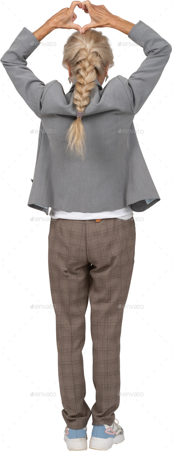 an older woman wearing a blue shirt and brown pants Stock Photo by