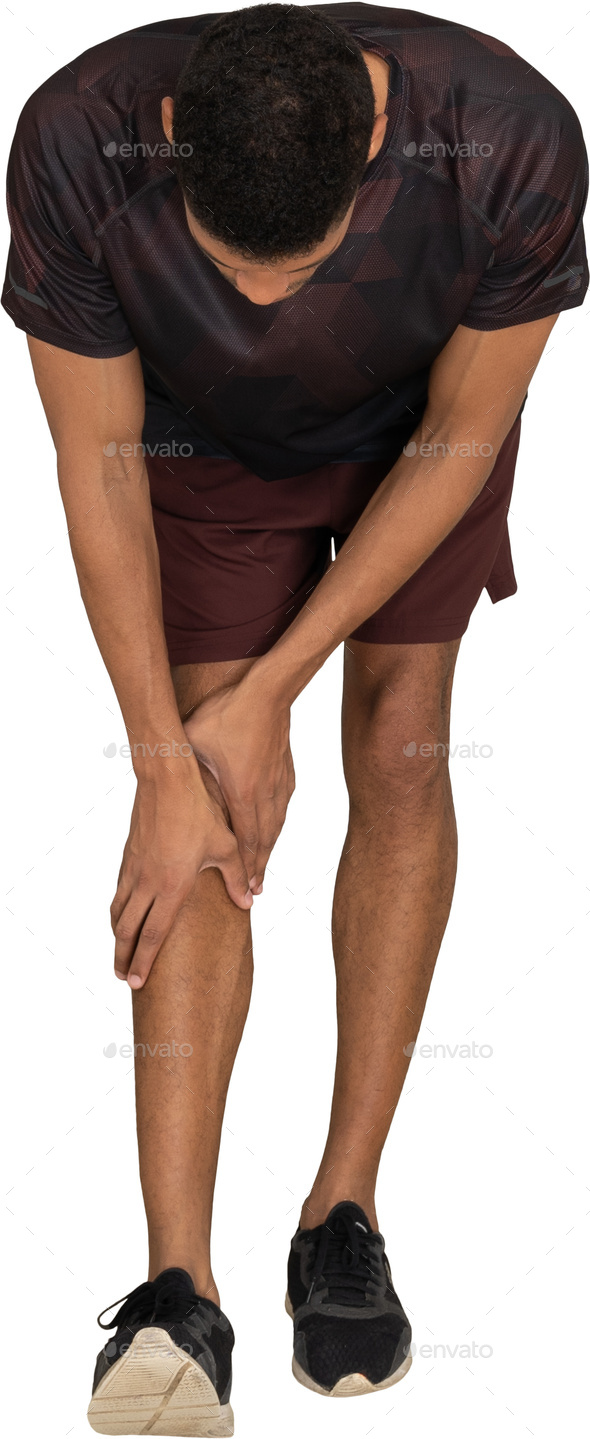 a man is kneeling down with his hands on his knee