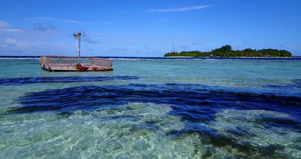 Daytime drone tourism shot of a white sandy paradise beach and turquoise sea background in hi res 4K alt