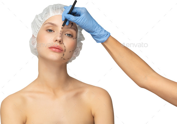 a woman with a towel on her head getting her eyebrows waxed