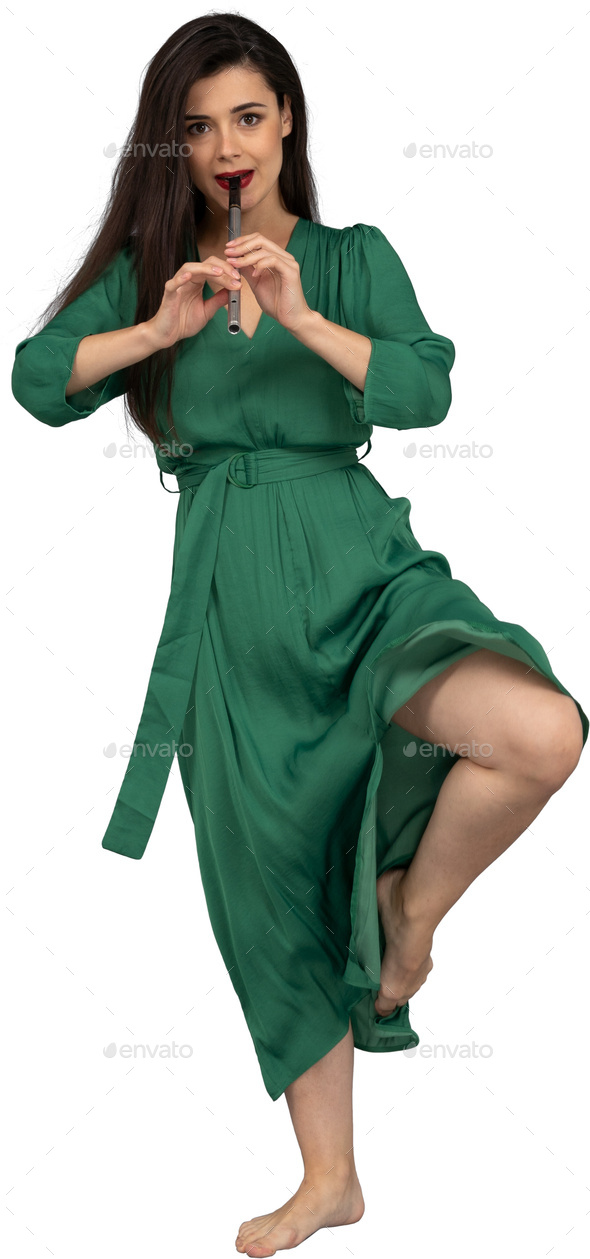 a woman in a green dress with her leg up in the air