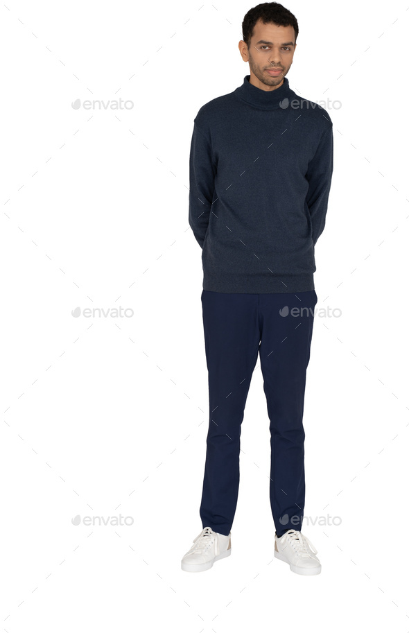 a man wearing a navy blue sweatshirt and navy blue pants and white shoes