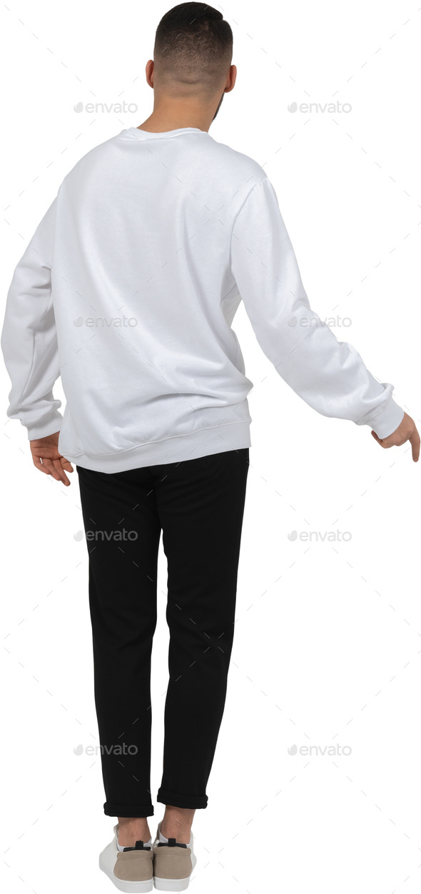 a man in a white sweatshirt and black pants holding his hand up to his