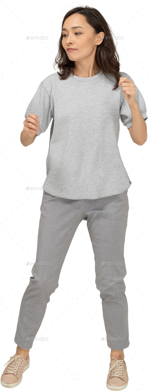 a woman in gray sweatpants and a gray shirt - Stock Photo - Images