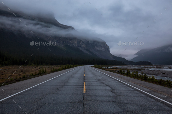 Gloomy and Moody picture of a Road with mountains in the background
