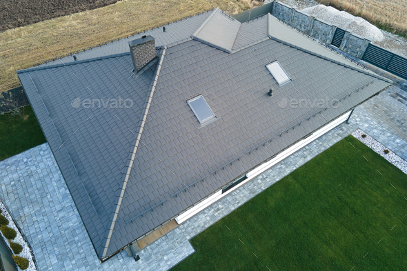 Aerial view of private house with ceramic shingles covered roof top. Investment in real estate