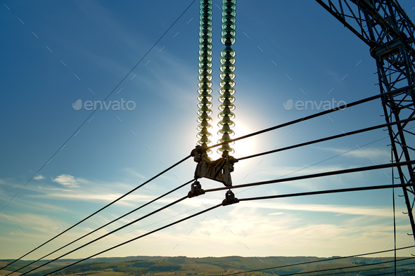High voltage insulation string on steel pillar with electric power lines for safe delivering of