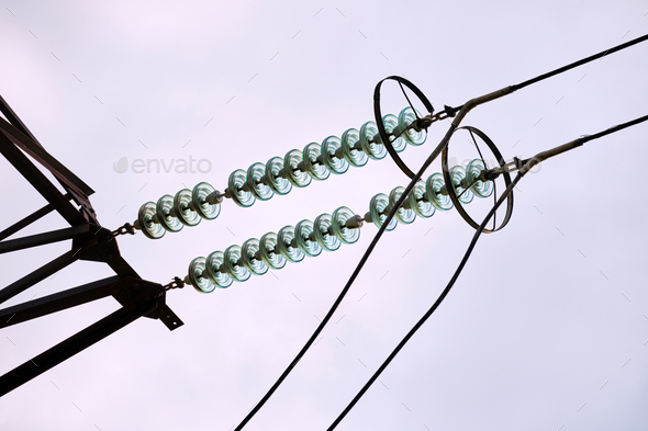 High voltage tower with electric power lines divided by safe guard bushing transfening safely