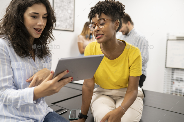 coworkers using tablet in coworking - Stock Photo - Images