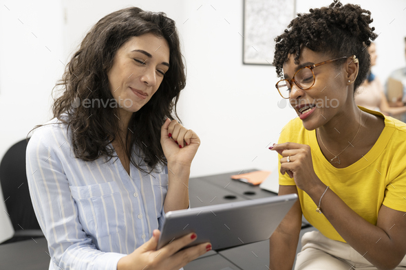 multiracial coworkers using tablet in coworking - Stock Photo - Images