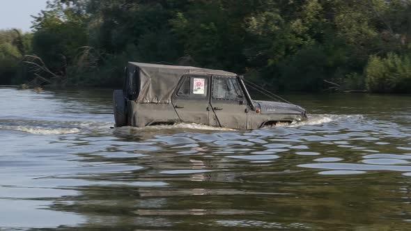 Teterev, Ukraine, 09.12.21. The car crosses the off-road competition river.