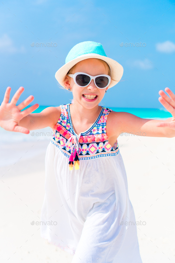 Portrait of adorable little girl at beach during summer vacation