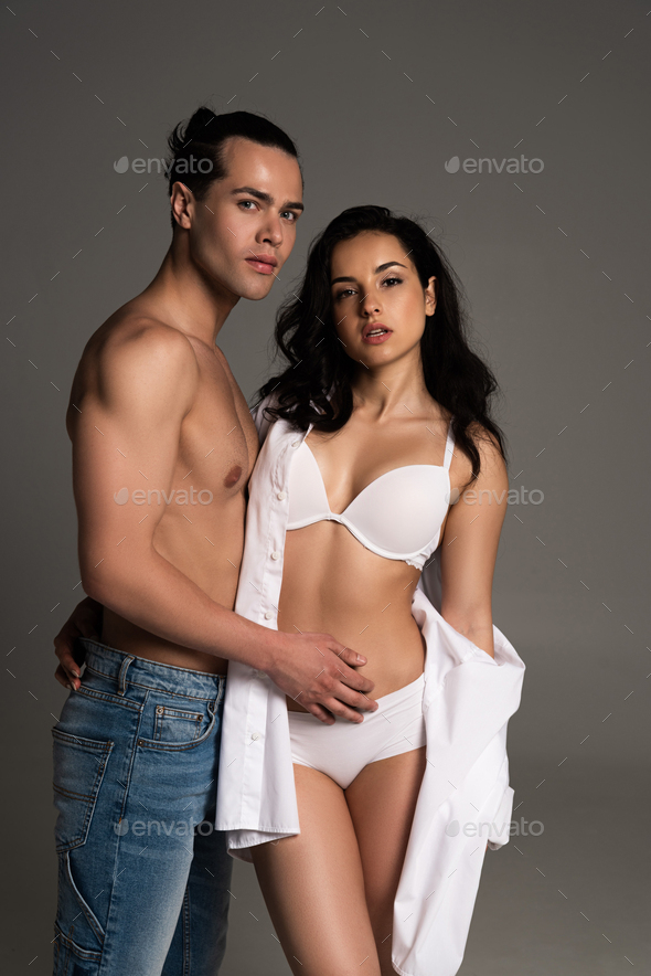 Young Interracial Women Bras Jeans Looking Camera Isolated Grey