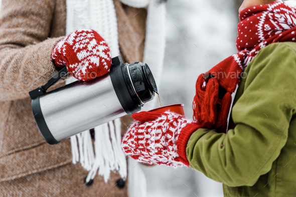 Crop Woman Pouring Hot Drink From Thermos by Stocksy Contributor