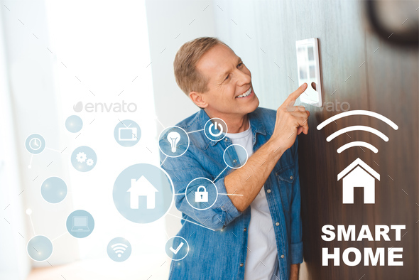 happy man using smart house control panel at new home