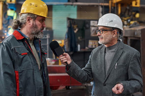 Factory worker giving interview to journalist