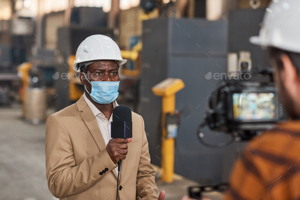 TV journalist having reportage in plant in pandemic