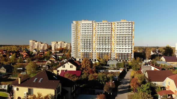 High-rise Residential Building Under Construction Among Private Houses in Russia