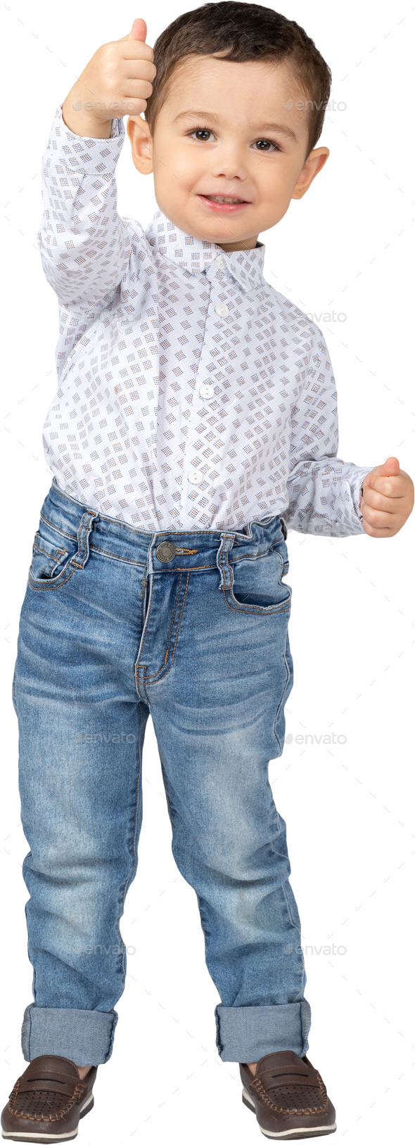 a little boy wearing jeans and a white shirt with his hand in the air