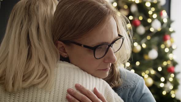 Video of sad mother cuddling with her adult daughter. Shot with RED helium camera in 8K. alt