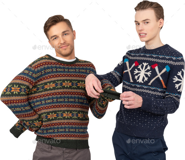 two men wearing ugly sweaters in front of a black background