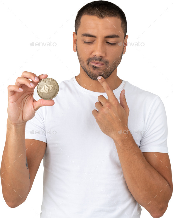 a man holding a coin with his finger on his mouth