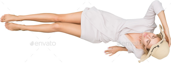 a woman in a white dress laying on the floor with her legs crossed