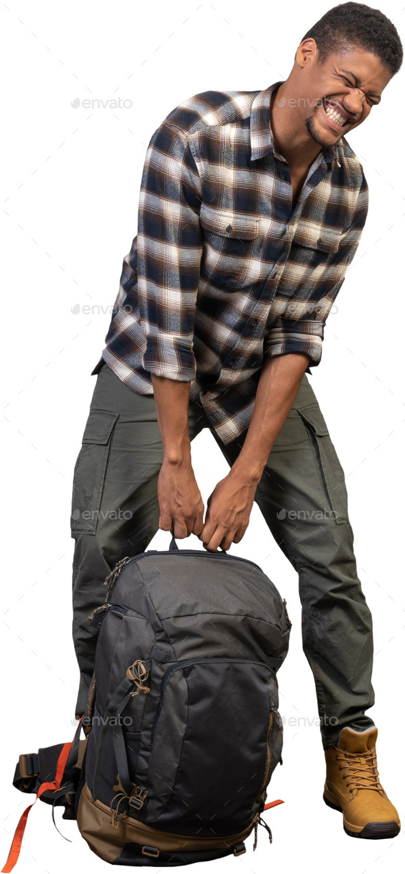 a man is kneeling down with a backpack - Stock Photo - Images