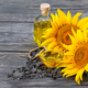 Flowers and sunflower seeds with oil in bottle and dish on table - PhotoDune Item for Sale
