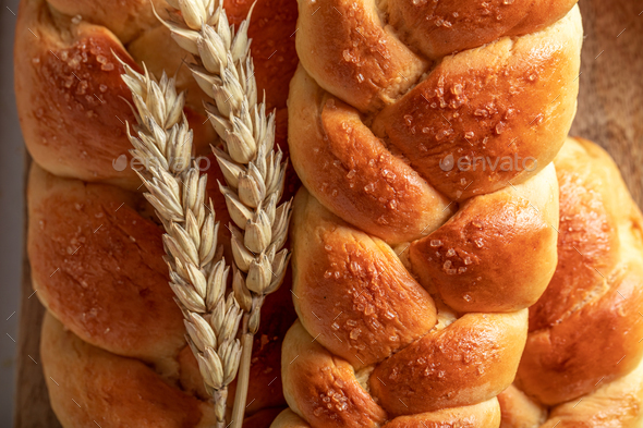Golden variety of breads with seeds and ears of grains.