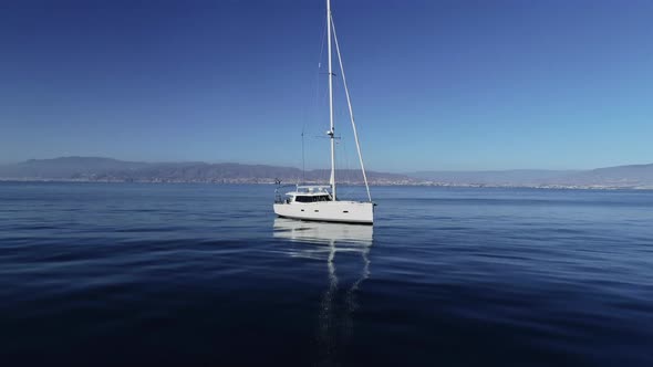 Sailboat Floating on Tranquil Sea alt