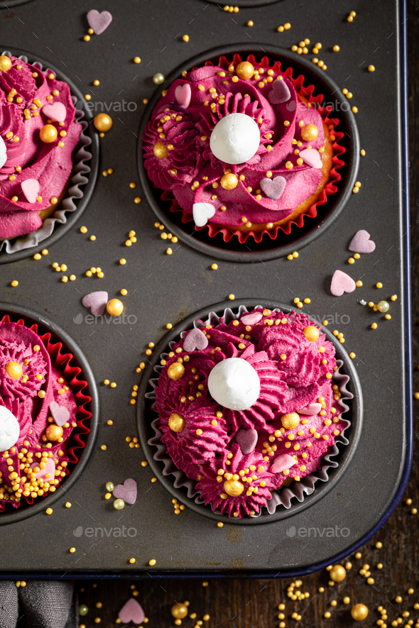 Homemade red cupcakes made of sprinkles and whipped cream. Stock Photo