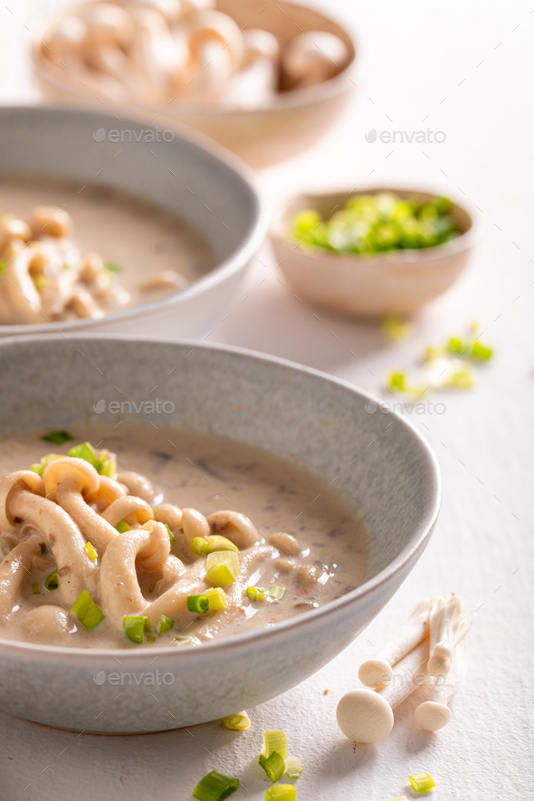 Aromatic shimeji mushroom soup with cream and chives. Stock Photo by