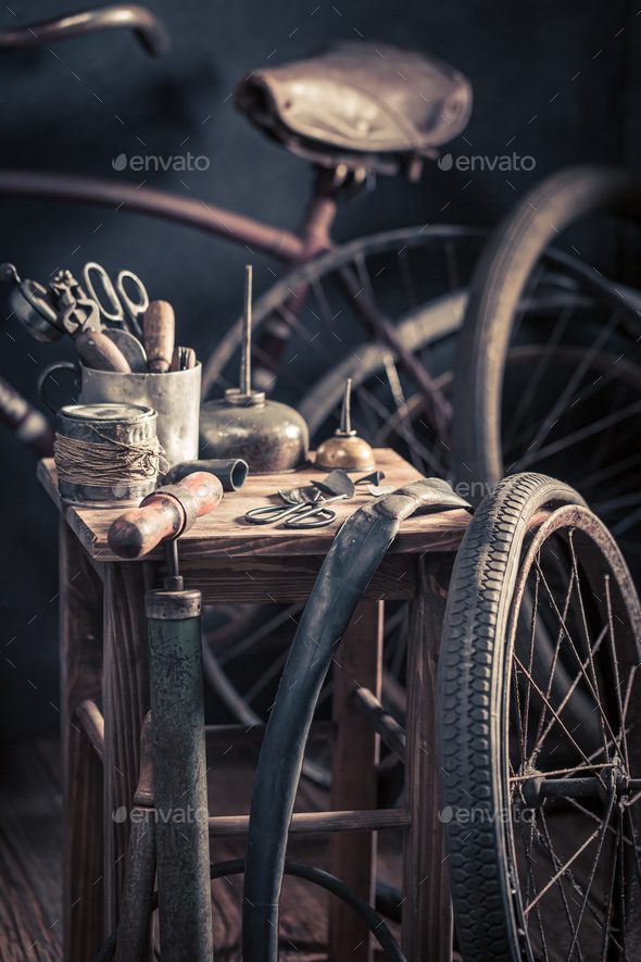 Vintage bike fix service with tools and wheels. Repair shop
