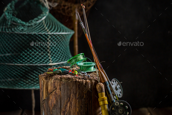 Vintage fishing tackle with rod and lures. Fishing equipment. Stock Photo  by Shaiith