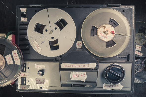 Vintage reel audio recorder and tape rolls. Audio reel player