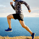 male athlete running trail on sky and sea background - PhotoDune Item for Sale