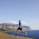 male athlete running uphill trail on sky and sea background - PhotoDune Item for Sale