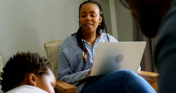 Close-up of young black father playing with his son in living of comfortable home 4k alt