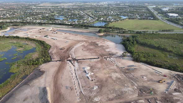 aerial circling South Florida, land development, and installation of infrastructure for a new neighb alt