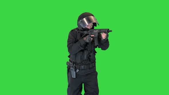 Police Operator with Assault Rifle Black Uniforms Aiming and Shooting on a Green Screen Chroma Key alt