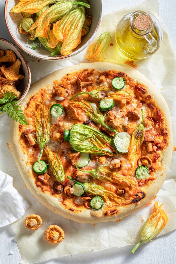 Vegetarian pizza with zucchini flower, chanterelles and mozzarella