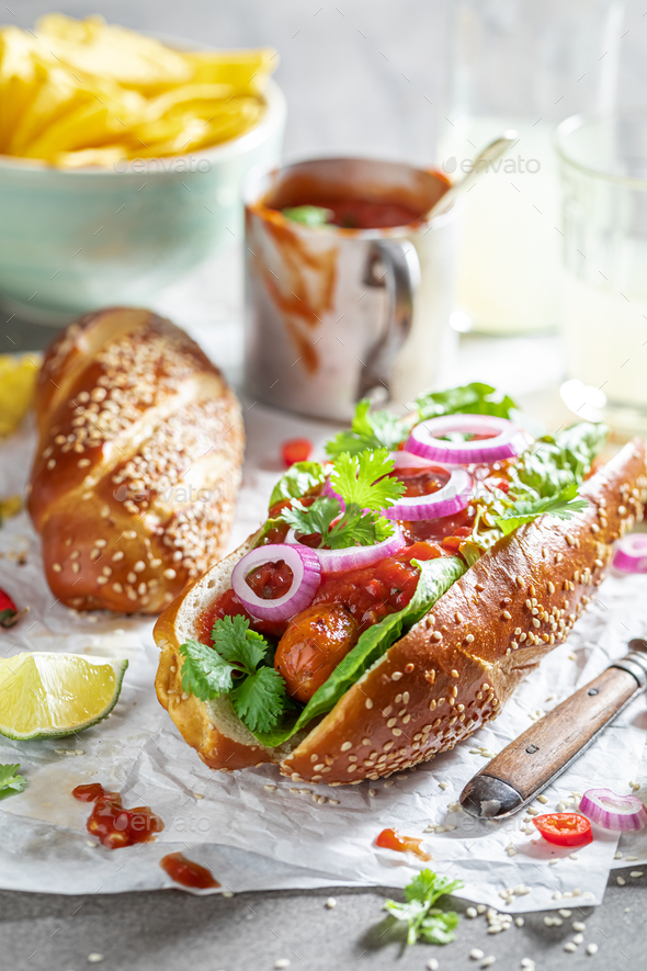 Tasty barbecue hot dogs with red sauce and coriander Stock Photo by Shaiith