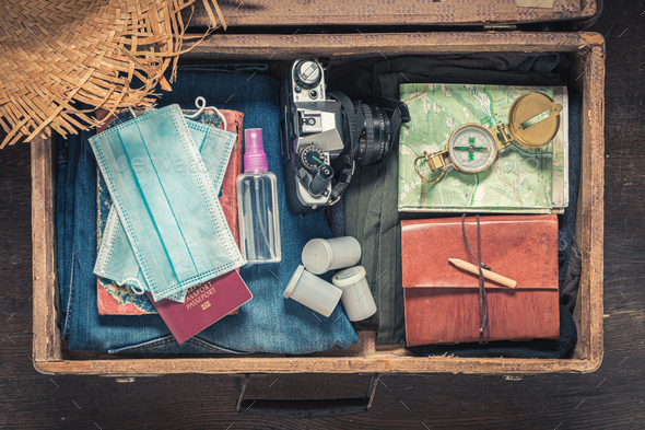 Luggage and mask as travel limitation. Epidemic limitation - Stock Photo - Images