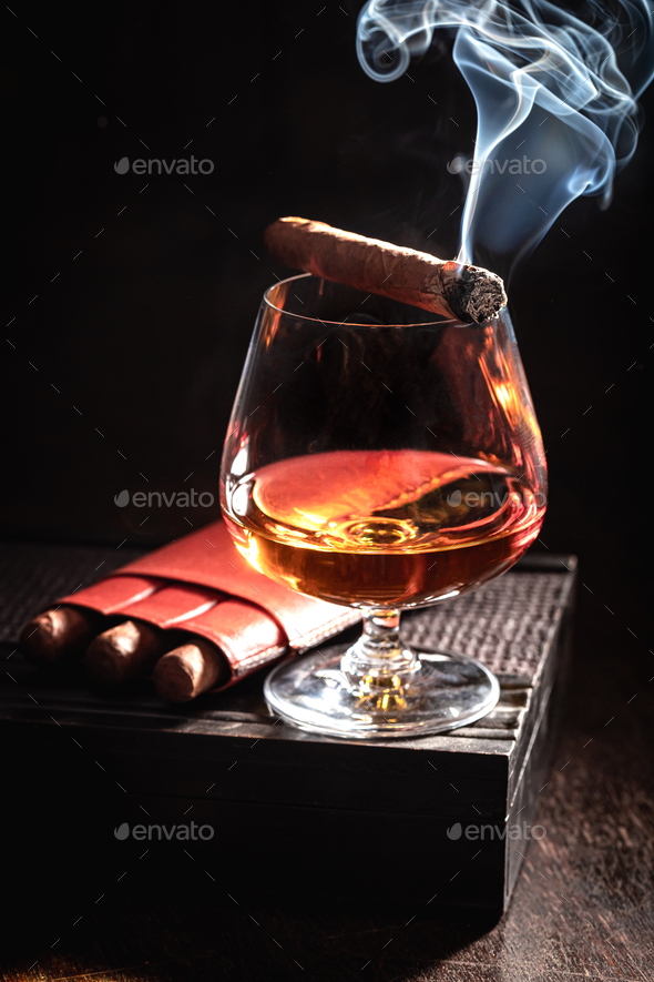 Bourbon and smoking cigar on old humidor
