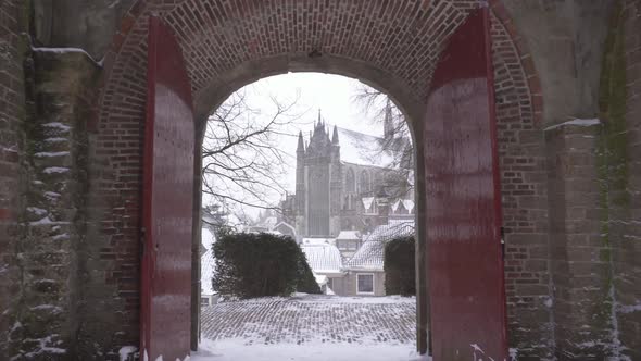 Burcht van Leiden, city reveal walking through fort gate in winter snow alt