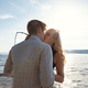 Romantic couple kissing on beach against the sun - PhotoDune Item for Sale